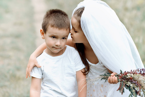 Young bride and groom playing wedding summer outdoor. Children l - Foto, Imagem