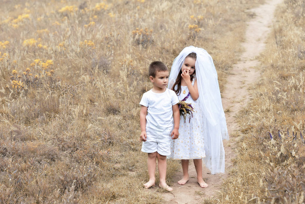 Young bride and groom playing wedding summer outdoor. Children l - Photo, Image