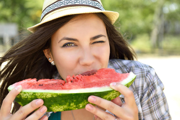Happy young woman eating watermelon on the beach. Youth lifestyl - 写真・画像