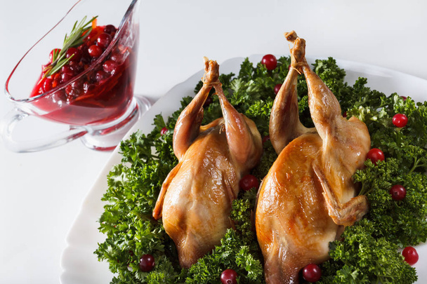 Carcasses of quail roasted with cranberry and parsley - Фото, изображение