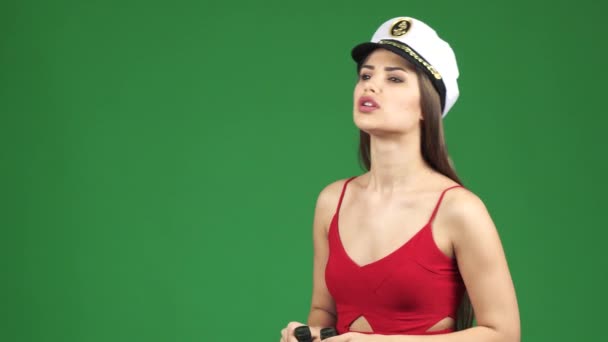 Lenyűgöző nő egy tengerész Cap mosolyogva után el belenéz a távcső - Felvétel, videó