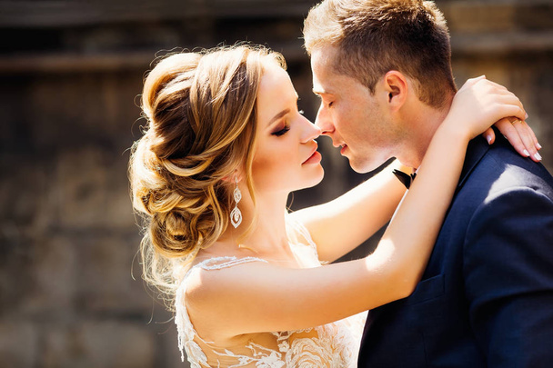 The bride hugs his groom around his neck and wants to kiss her - Photo, Image