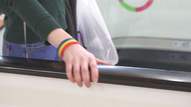 female hand on escalator, symbol of lgbt support - Materiał filmowy, wideo