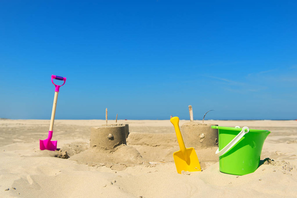 Sand castle with toys at the beach - Foto, imagen