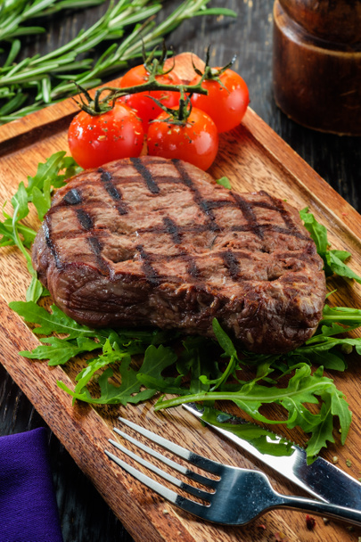Grilled beef steak on wooden cutting board. - Photo, Image