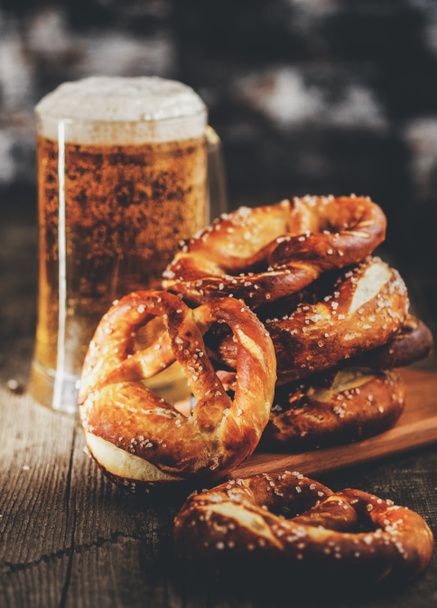 Freshly baked homemade soft pretzel with salt on rustic wooden t - Photo, Image