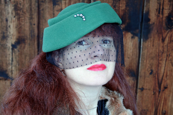 緑の帽子と黒いベールできれいな女性 - 写真・画像