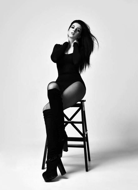 Young beautiful sexy woman posing sitting in summer fashion body vest on chair  tights black - Фото, зображення