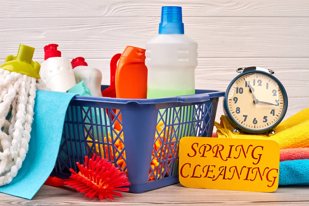 Basket with cleaning items on wooden background. - Photo, Image