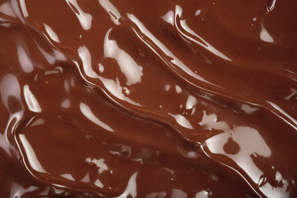Розплавлений шоколадний вихор як фон крупним планом
 - Фото, зображення