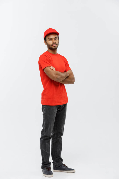 Delivery Concept - Handsome African American delivery man crossed arms over isolated on Grey studio Background. Copy Space. - Photo, Image