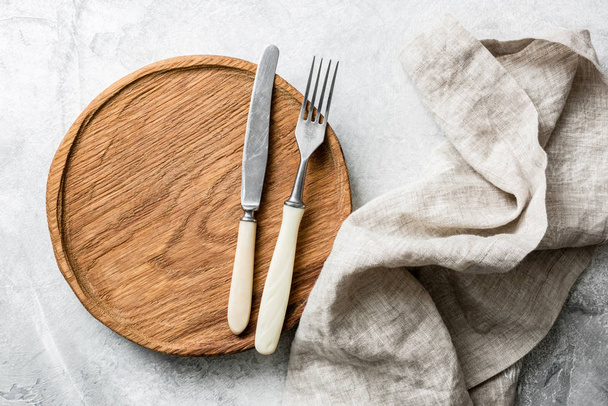 Rustic table setting with vintage silverware, wooden board and textile - Foto, immagini