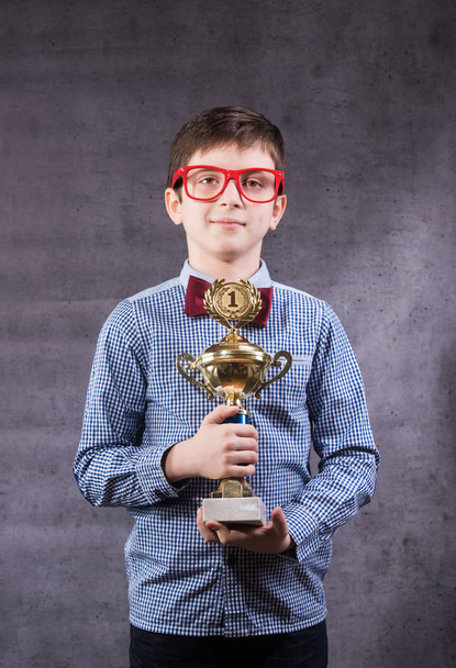 Little boy celebrates his golden trophy - Foto, immagini