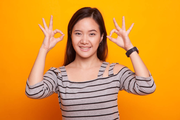 Asian woman show double OK hand sign  and smile. - Foto, Imagen