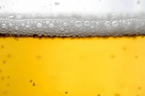 Pouring beer with bubble froth in glass for background  - Zdjęcie, obraz