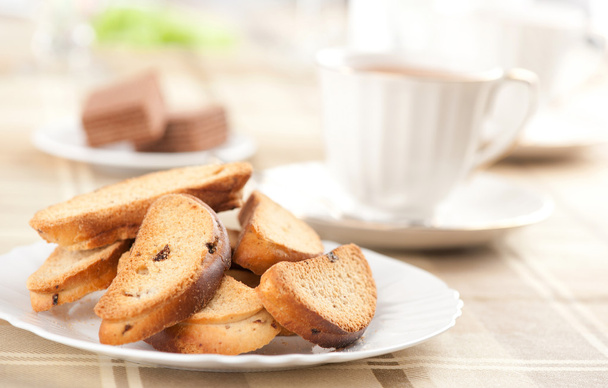 Rusk with raisin on a plate - Фото, изображение