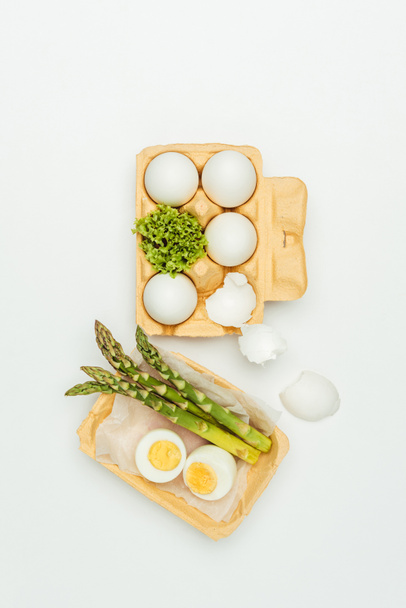 top view of eggs with tray and asparagus isolated on white - Fotoğraf, Görsel