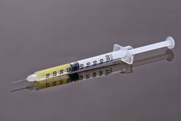 Syringe and needle on grey background - Fotoğraf, Görsel