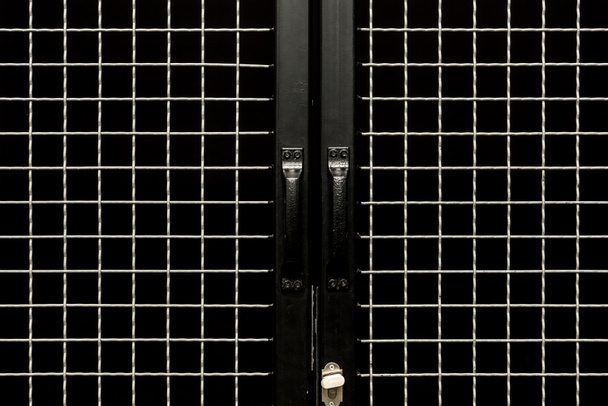 Black doors with handles and metal grit - Foto, imagen