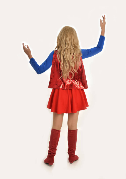retrato de longitud completa de chica bonita con traje de superhéroe, pose de pie, aislado en el fondo del estudio blanco
. - Foto, imagen