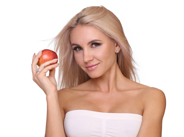 blond woman eat red apple - Fotó, kép