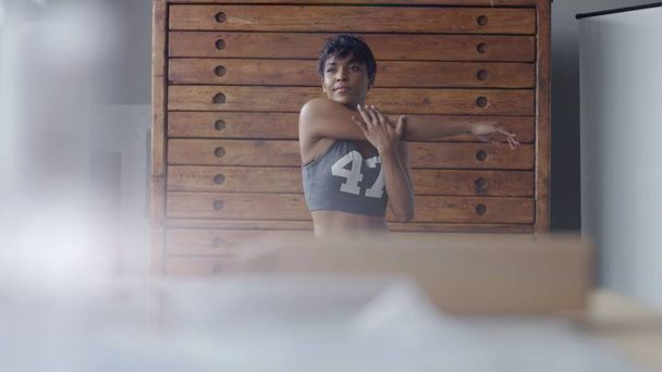 giovane in forma e tonificare donna facendo stretching routine nel soleggiato loft
 - Foto, immagini