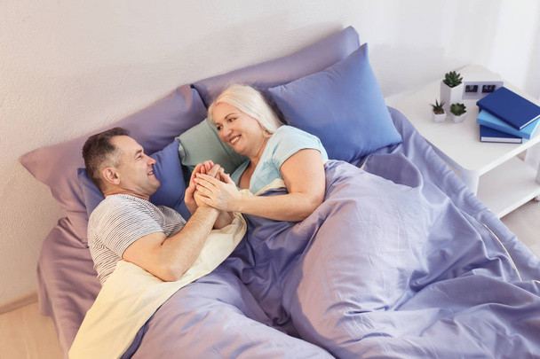 Senior couple in bed together - Фото, зображення