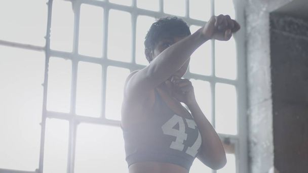 fiatal vegyes faj afrikai-amerikai nő teszi egy box workout napos loft - Fotó, kép