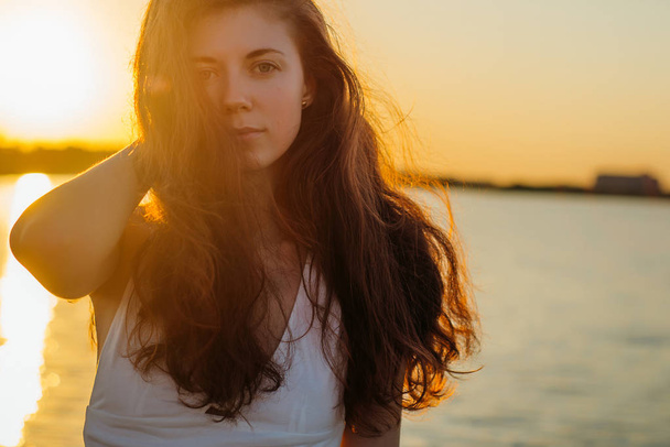 Portrait d'une femme aux cheveux longs au coucher du soleil
 - Photo, image