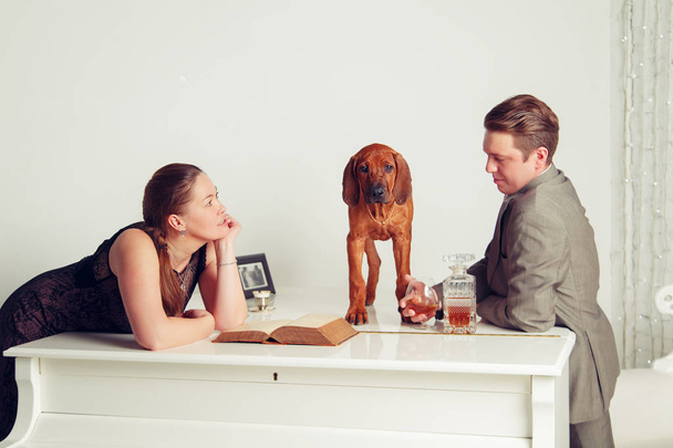Successful businessman with his wife and dog. - Foto, afbeelding