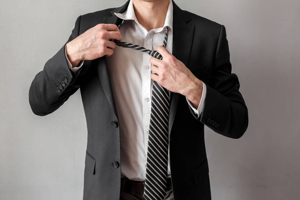 Businessman untying tie - Φωτογραφία, εικόνα