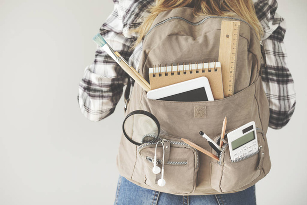 Student carrying backpack with stationery equipments - 写真・画像