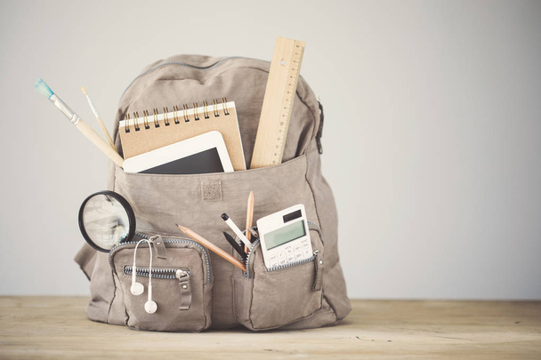 Backpack school supplies on table emtpy background - Φωτογραφία, εικόνα