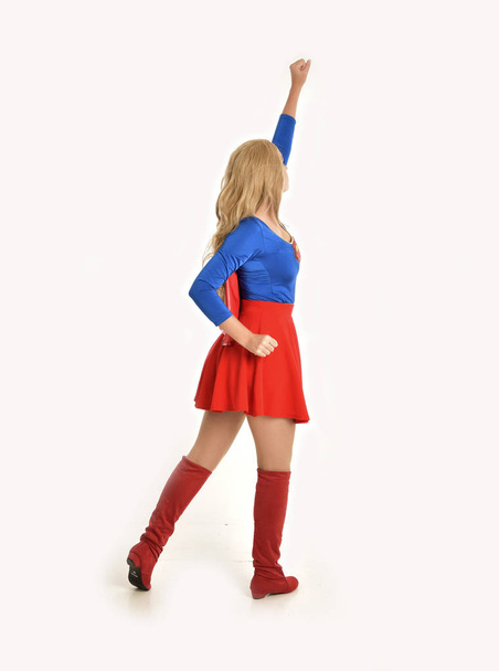 full length portrait of pretty girl wearing super hero costume, standing pose, isolated on white studio background. - Photo, Image