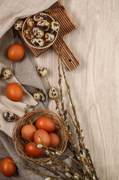 quail and chicken eggs with willow branches - Фото, зображення