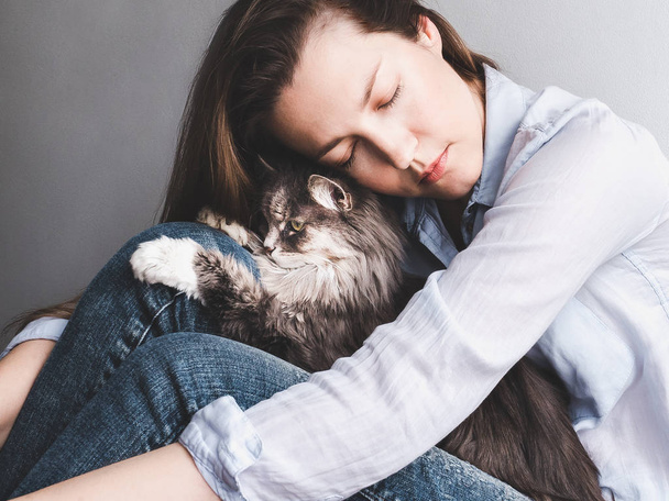 Stylish woman gently hugging kitten - Photo, Image