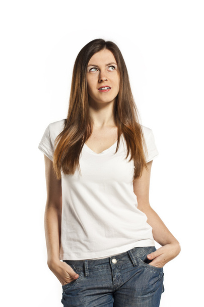 Beautiful young brunette in a white T-shirt in the studio - 写真・画像