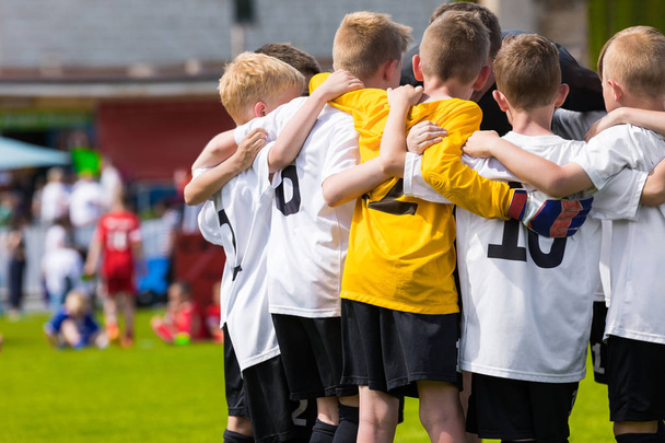 Children Soccer Team. Kids Football Academy. Young Soccer Players in Jersey Shirts Standing Together on the Pitch. Coach Motivational Talk with Boys. Youth Soccer Motivate Speech. School Tournament - Photo, Image