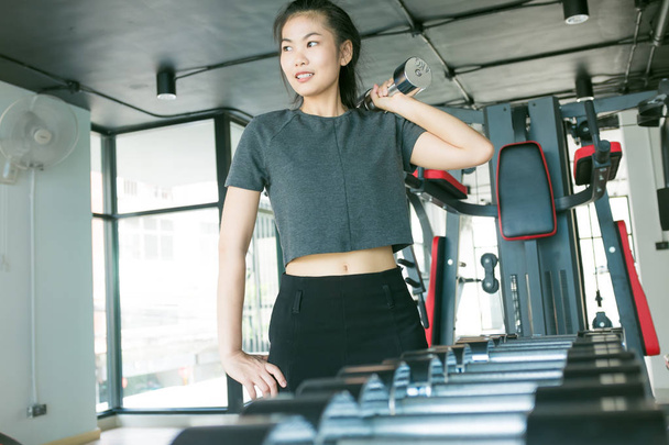 Las mujeres que hacen ejercicio con pesas de metal en el gimnasio moderno, Wor out fitness
 - Foto, Imagen