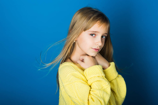 Beauty, kid fashion, cosmetics, healthy hair. Fashion model, beauty, look. Little girl with long hair. Stylish girl with pretty face on grey background. Hairdresser, skincare, casual style, denim. - 写真・画像