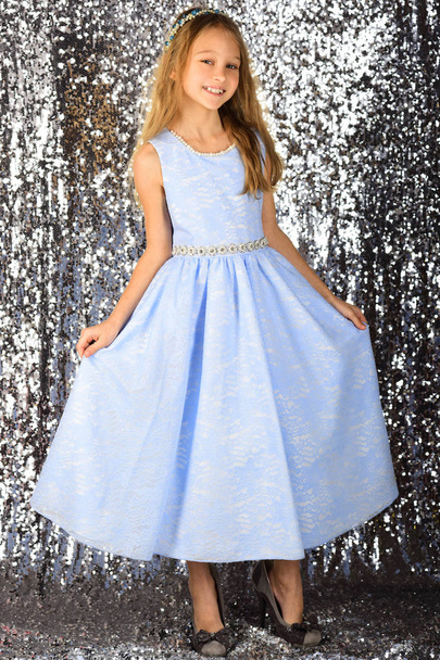 Look, hairdresser, makeup. Little girl in fashionable dress, prom. Child girl in stylish glamour dress, elegance. Fashion and beauty, little princess. Fashion model on silver background, beauty. - Photo, image