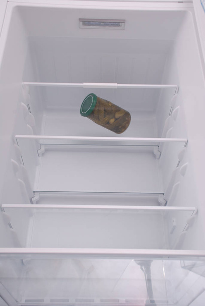 Pickled cucumbers inside in empty clean refrigerator - Photo, Image