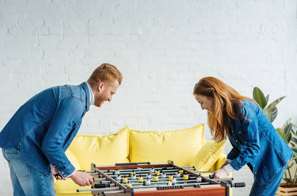 Young happy couple playing table football - Foto, Bild