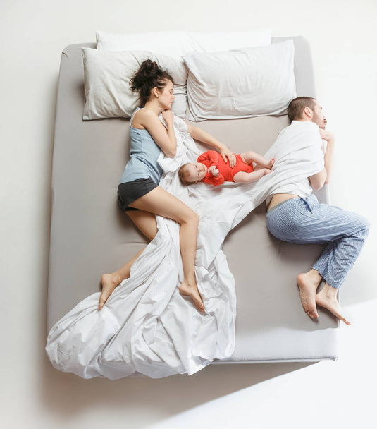 Top view of happy family with one newborn child in bedroom. - Valokuva, kuva