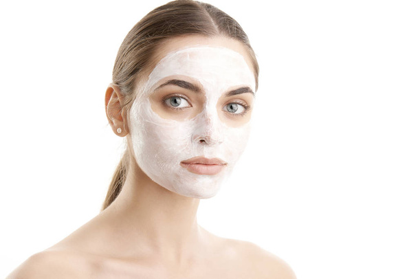 Close-up shot of a beautiful young woman wearing a face mask. Isolated on white background.  - Foto, afbeelding