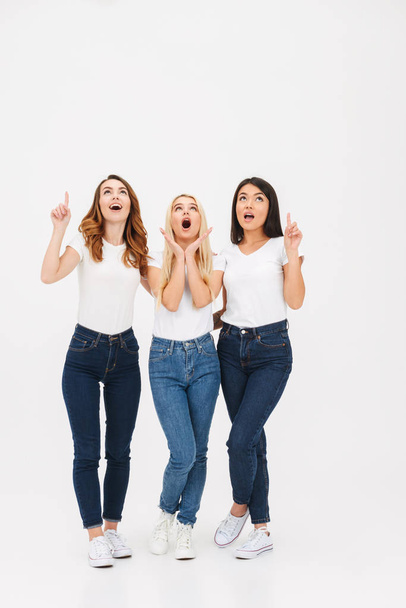 Full length portrait of three surprised casual girls - Фото, изображение