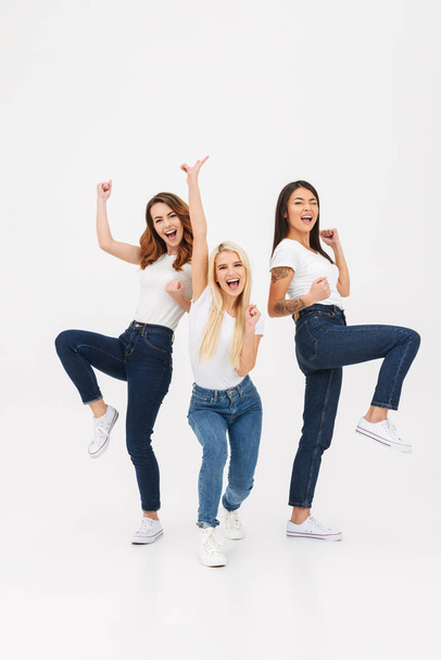 Full length portrait of three cheery casual girls - Фото, изображение