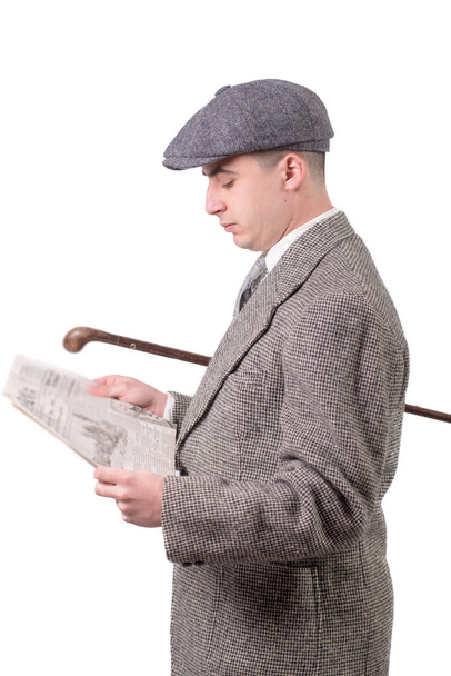 young man in vintage clothes with hat, reading a newspaper, 1940 - Photo, Image