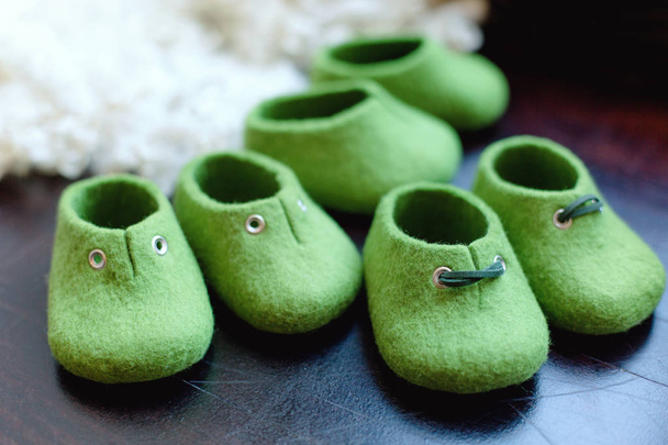 Handcrafted merino wool baby shoes green color - Photo, Image