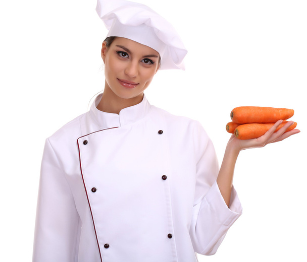 Portrait of young woman chef with vegetables isolated on white - Фото, изображение